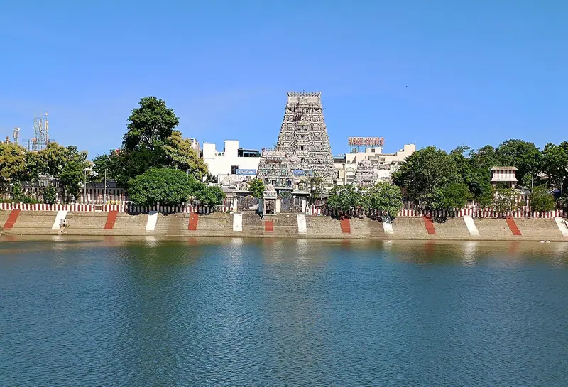 The painted gopuram of Kapaleeshwarar Temple rising behind the temple tank